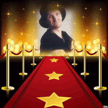 a red carpet with gold stars and a picture of a man in a hat