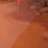 a couple of people are standing next to each other on a red surface .