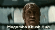 a close up of a man 's face with the words mogambo khush hua written above him .