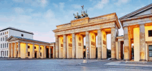 a large building with columns and a horse on top of it is called the berlin gate .