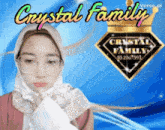a woman wearing glasses and a head scarf is standing in front of a crystal family logo