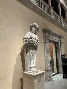 a statue of a woman holding flowers in her hands