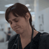 a woman with a stethoscope around her neck has a sad look on her face