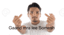 a man making a middle finger gesture with the words gaand mra lee somesh behind him