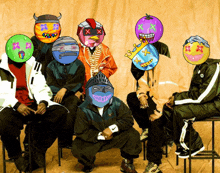 a group of people with colorful masks on their faces are posing for a picture