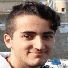 a close up of a young man 's face with a beard .