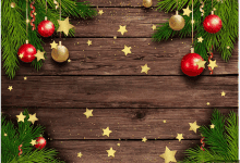 a wooden background with christmas decorations hanging from the branches