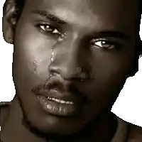 a close up of a man 's face with a tear running down his face
