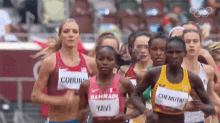 a group of female runners are running in a race and one of them has a name tag that says coburn