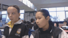 two girls wearing uniforms for o'brien's primary college