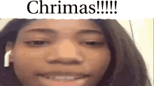 a close up of a girl 's face with the words chrimas written above her .