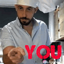 a man wearing a chef 's hat is pointing at the camera with the word you behind him