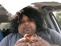 a man in a car is eating a donut with a starfish on it