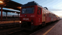 a red train with the word skpl on the side