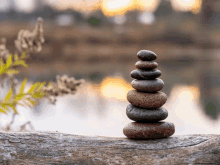 a stack of rocks sitting on a piece of wood