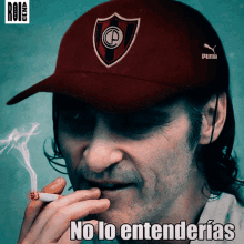 a man smoking a cigarette wearing a red puma hat