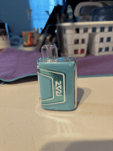 a light blue raz device is sitting on a counter