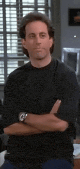 a man with his arms crossed is wearing a watch on his wrist