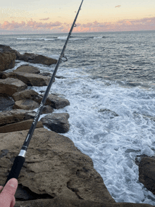 a person is holding a fishing rod that says ' fuji ' on the handle