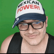 a man wearing glasses and a mexican power hat