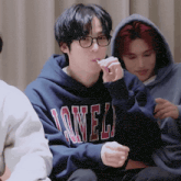 a young man wearing a hoodie that says lonel