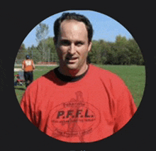 a man wearing a red shirt that says p.r.f.l. on it