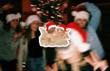 a group of people wearing santa hats with a picture of two angels on the bottom