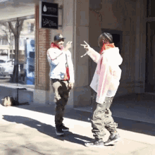 two men are standing on a sidewalk in front of a building that has a sign that says blue flame