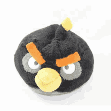 a black angry bird with a yellow beak