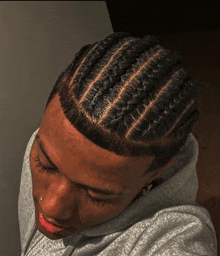 a close up of a person 's head with braids