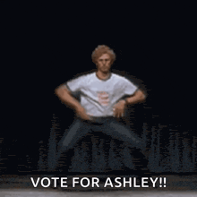a man in a white t-shirt is dancing and says vote for ashley !