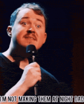 a man singing into a microphone with the words " i 'm not making them at night dad " below him