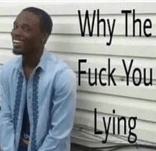 a man is sitting in front of a wall with the words `` why the fuck you lying '' on it .