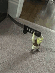 shrek from shrek is holding a large knife on a carpet .