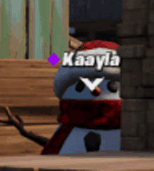 a snowman wearing a santa hat and scarf with the name kaayda on it .