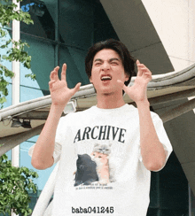 a man wearing a white t-shirt that says archive