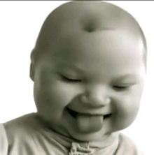 a baby is sticking its tongue out while smiling