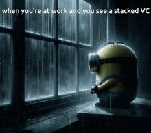 a picture of a minion sitting in front of a window with a caption that says when you 're at work