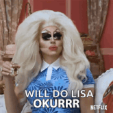 a drag queen says " will do lisa okurrr " while holding a glass