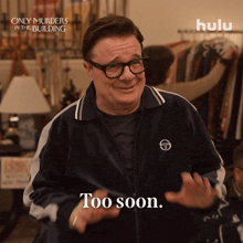 a man wearing glasses and a jacket says " too soon "