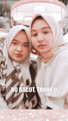 two women posing for a picture with the words no bacot thank u