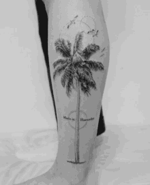 a person has a tattoo of a palm tree and the words made in haeundae