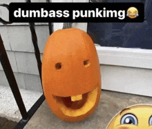 a pumpkin with a face carved into it and the words dumbass punking on the bottom