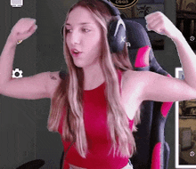 a woman wearing headphones is flexing her muscles in front of a csgo logo