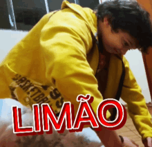 a person wearing a yellow jacket with the word limao on the bottom