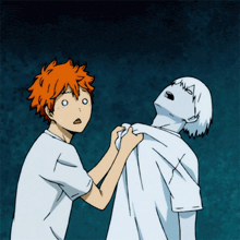 a boy with orange hair is holding another boy 's arm