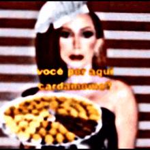 a woman in a chef 's hat is holding a plate of food with the words voce por aqui cardamom on the bottom