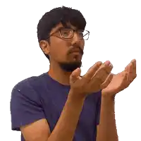a man wearing glasses is clapping his hands