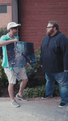 two men standing next to each other one of whom is holding a sign that says ' i love you ' on it