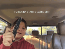 a person holding a knife in a car with the words i 'm gonna start stabbin shit written above them